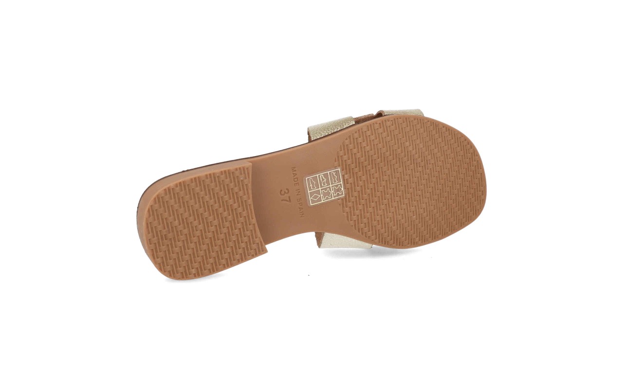Cuatro variantes de la sandalia plana de piel modelo 105 con pala en forma de H, detalle de hebilla dorada central y planta de confort acolchada.